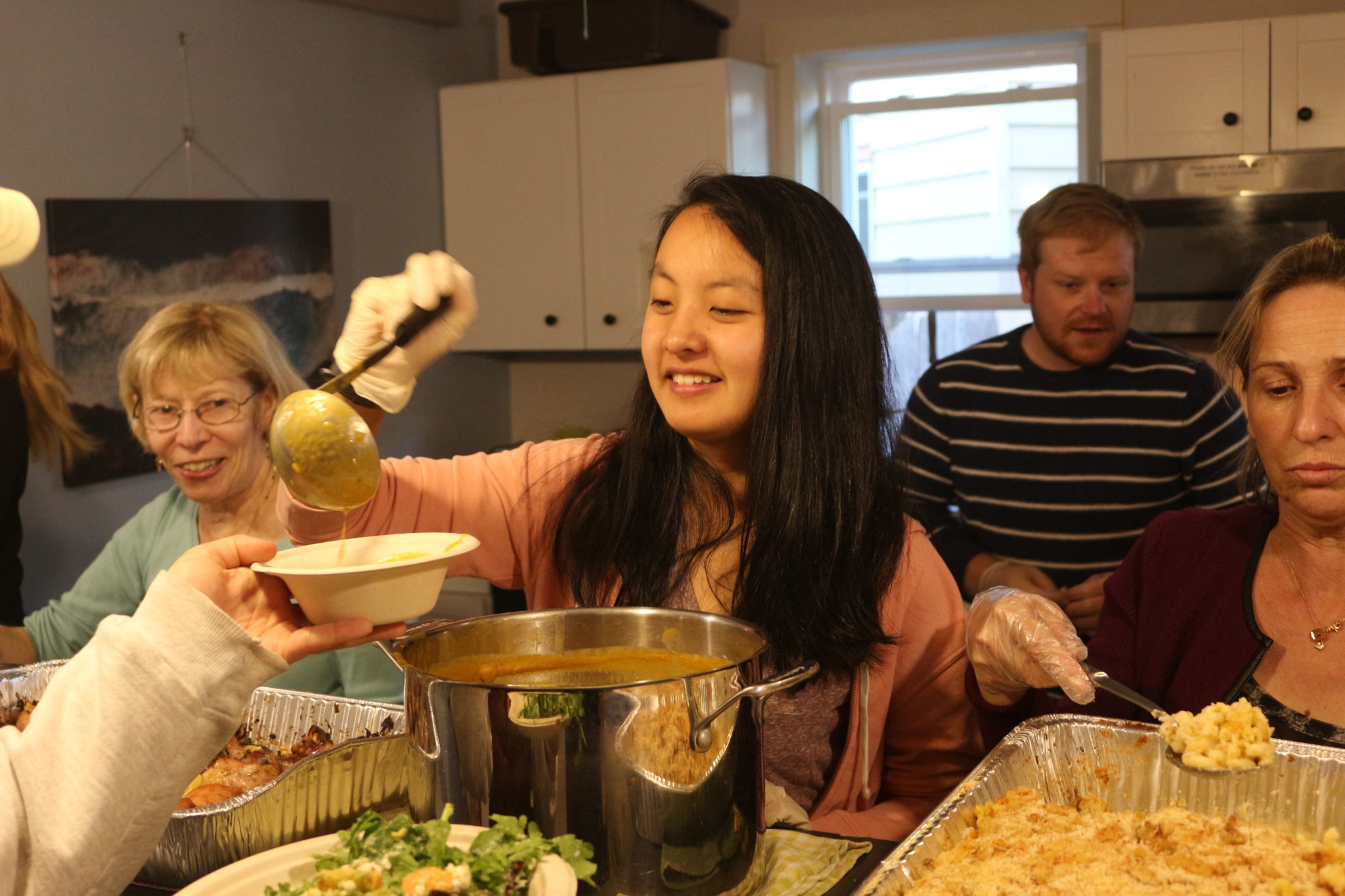 People gathered in a kitchen serving food